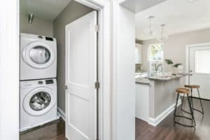Laundry room with washer and dryer in entrance to brand new kitchen