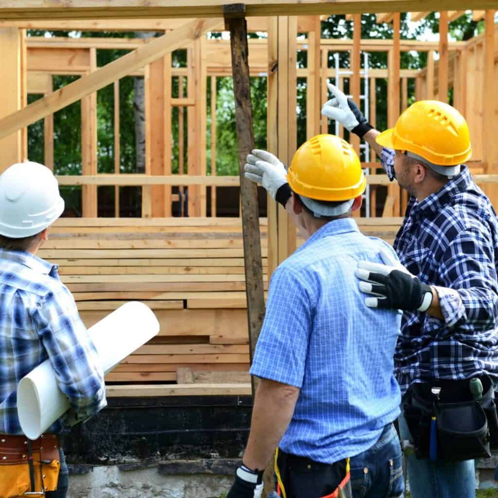 Construction Workers Looking at a home