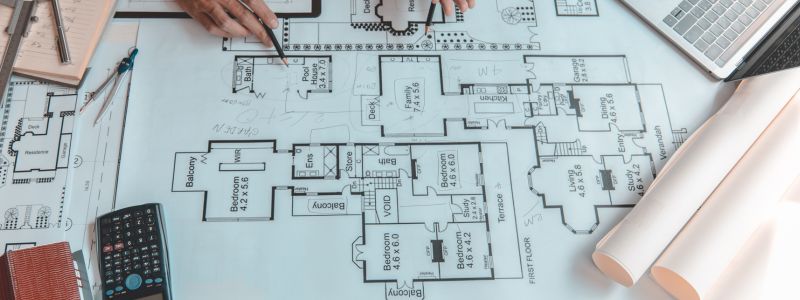 A home designer looking at a floor plan